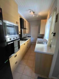 a kitchen with a sink and a stove top oven at East Stay 2/3 bedroom Flat in Westoe
