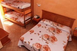 a bedroom with two beds with roses on the sheets at Hotel LA LOGGIA in Castel di Sangro