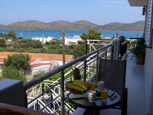 a table with bananas on it on a balcony at Luxury Rofos Residence in Elounda