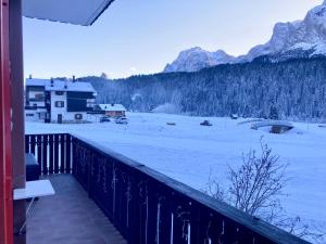 a balcony with a view of a snow covered field at Casa Isotta Sappada in Sappada