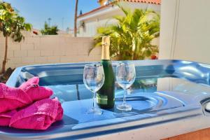a bottle of champagne and two wine glasses on a tray at Villa Julia Relax Dream Holiday in Callao Salvaje