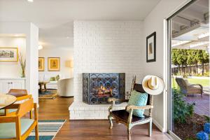 a living room with a white brick fireplace at Hummingbird Haven in Santa Barbara