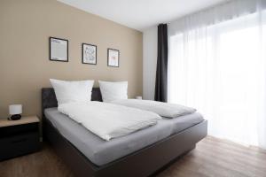 Postel nebo postele na pokoji v ubytování Schicke Apartments in Osnabrück I private Parkplätze I home2share