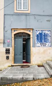 a building with a blue door on the side of it at Sé Velha Suites in Coimbra