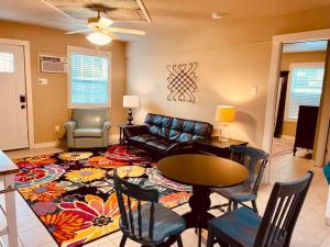 a living room with a couch and a table and chairs at Elm Street Cottage in Seguin