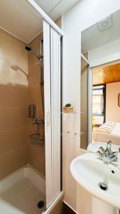 a bathroom with a sink and a shower at Sé Velha Suites in Coimbra +77 photos