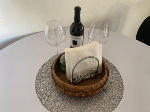 a bottle of wine and two wine glasses on a table at Center Street Villas in Joshua Tree