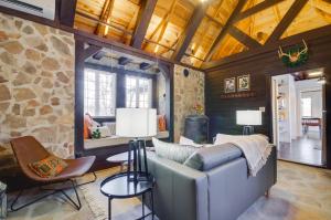a living room with a couch and a stone wall at Cozy Steelville Retreat River and Trail Access! in Steelville