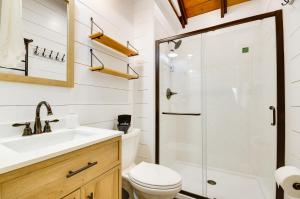a bathroom with a toilet sink and a shower at Cozy Steelville Retreat River and Trail Access! in Steelville +32 photos