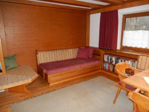 een kamer met een bank en een boekenplank bij Landhaus Gollner in Uderns