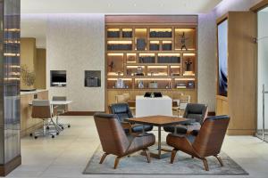 a dining room with a table and chairs at AC Hotel by Marriott Atlanta Airport Gateway in Atlanta