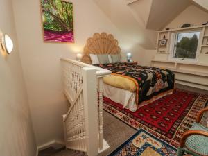 a bedroom with a king sized bed and a staircase at Still Waters in Ulverston