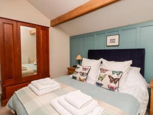 a bedroom with a bed with towels on it at Yate Cottage in Oxenhope