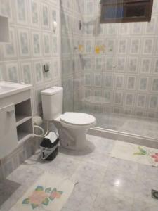 a bathroom with a toilet and a shower at Casa de Praia em Itaparica in Itaparica