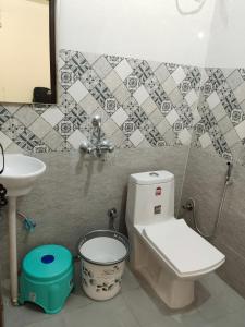 a bathroom with a toilet and a sink at JMD 13 Hotel in Gurgaon