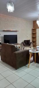 a living room with a couch and a table at Casa de praia in Japaratinga