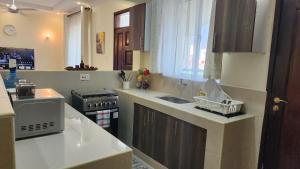 a kitchen with a sink and a counter top at Twin Palms Apartments, Bamburi, Mombasa in Mombasa