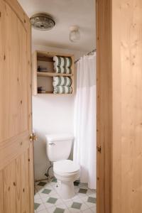 a bathroom with a white toilet in a room at 2411 - Oak Knoll Duplex Studio #14 cabin in Big Bear Lake