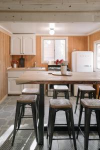 a kitchen with a large wooden table and stools at 2407 - Oak Knoll #9 cabin in Big Bear Lake