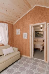 a living room with a couch and two beds at 2407 - Oak Knoll #9 cabin in Big Bear Lake