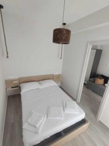 a white bed with two pillows in a room at Sparti Apartment in Limenas