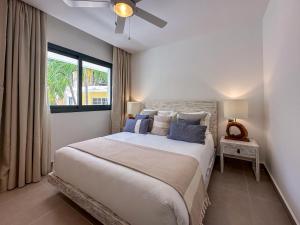 a bedroom with a large bed with a ceiling fan at Fantastic brand new beach home in Punta Cana