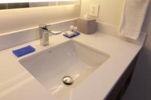 a white bathroom sink with a chrome faucet at Holiday Inn Express Guadalajara Iteso, an IHG Hotel in Guadalajara
