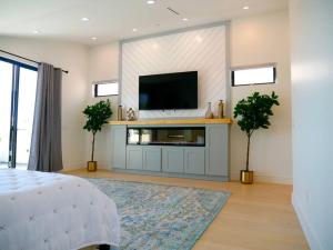 a living room with a flat screen tv on a wall at OC Oasis Beach Pad in Huntington Beach
