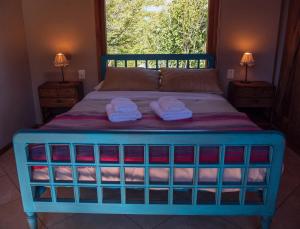 a bedroom with a bed with two towels on it at La Huala in San Carlos de Bariloche