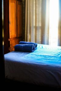 two blue pillows sitting on top of a bed at CABAÑAS DE MORA in Villa Santa Cruz del Lago