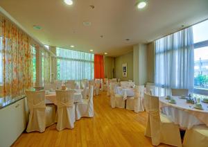 a banquet hall with white tables and chairs at Park Hotel in Athens