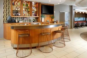 a bar in a restaurant with bar stools at SpringHill Suites Houston NASA/Webster in Webster