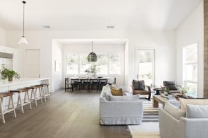 a living room with white furniture and a kitchen at Syrah by AvantStay Hilltop Haven in Sonoma Infinity Pool w Valley Views in Sonoma