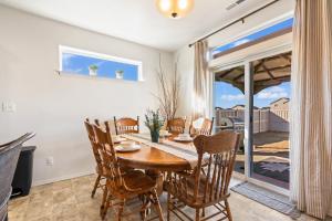 a dining room with a wooden table and chairs at Western Caldwell Charm in Caldwell