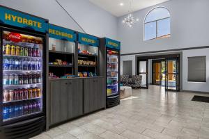 a store with two refrigerators with drinks in them at Clarion Pointe Hinesville near Fort Stewart in Hinesville