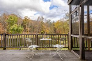 a patio with two chairs and a table on a deck at Cortland by AvantStay Charming Heritage Estate w Private Lake Pool in Saugerties
