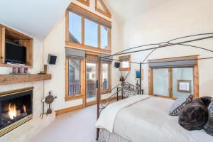 a bedroom with a bed and a fireplace at Telemark B by AvantStay Ski In Ski Out at the Heart of Mountain Village in Telluride