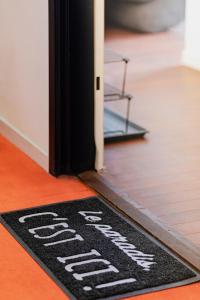 a welcome mat on the floor in front of a door at Studio Doux et Cosy Paris in Gentilly