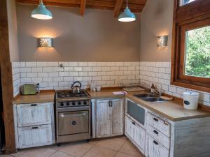 a kitchen with a sink and a stove top oven at La Huala in San Carlos de Bariloche +64 photos