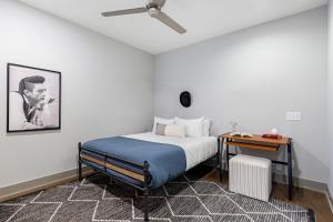 a bedroom with a bed and a nightstand and a table at Waverly by AvantStay Nashville-Inspired Townhome w Luxury Kitchen Pool Table in Nashville