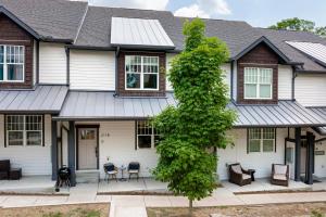 a house with a tree in front of it at Waverly by AvantStay Nashville-Inspired Townhome w Luxury Kitchen Pool Table in Nashville