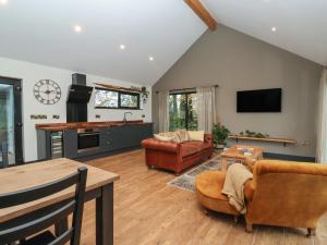 a living room filled with furniture and a flat screen tv at Blackcap in Huggate