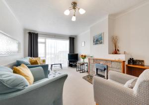 a living room with a couch and a fireplace at Primley Park in Paignton