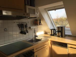 a small kitchen with a sink and a window at Fewo Zur Ilmenau in Melbeck