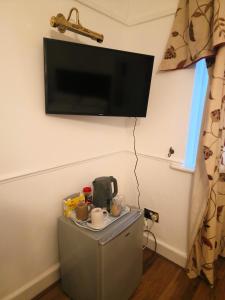 a flat screen tv hanging on a wall at 51 Nonsuch Walk, Cheam in Cheam