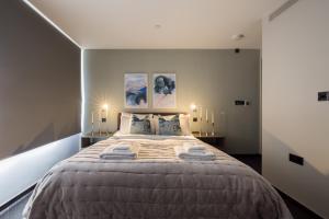 a bedroom with a large bed with towels on it at The Soho STAR in London