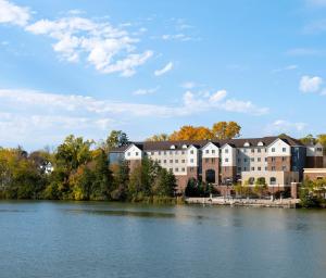 a building on the side of a river at Staybridge Suites Rochester University, an IHG Hotel in Rochester