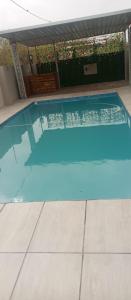 a swimming pool with blue water in a house at Josmot Guest House in Gaborone