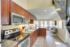 a kitchen with a sink and a stove top oven at Phoenix Nest South Haven Condo River View! in South Haven