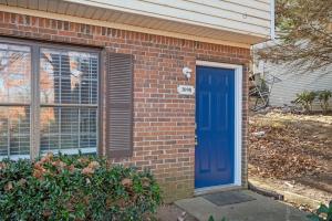 a blue door on the side of a brick house at Luxurious Extended Stay Dream~3 Kings~Desks~TV's in Snellville